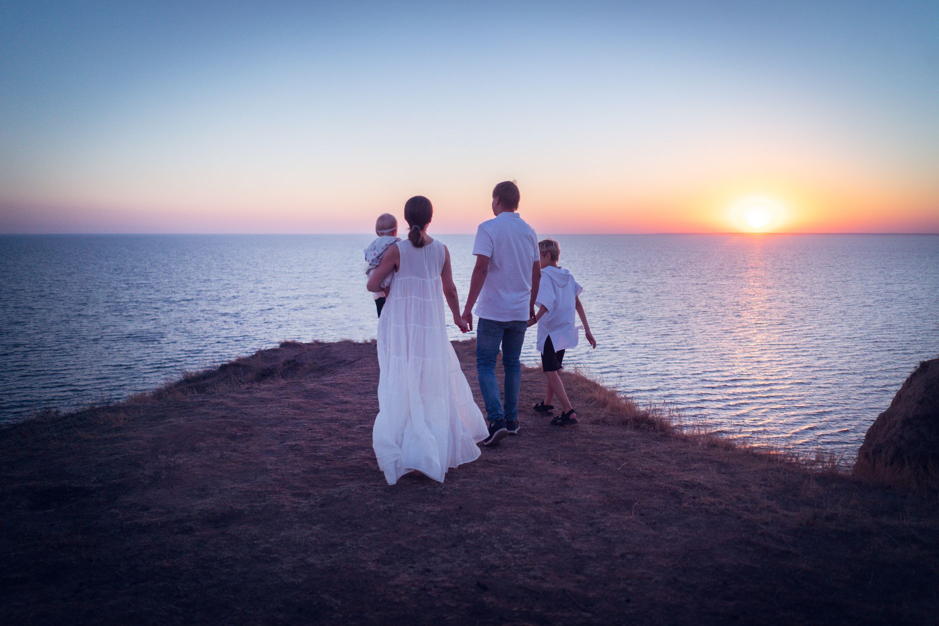A family silhouette together at sunset, love and togetherness