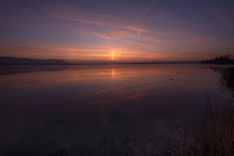 Peaceful sunrise over a tranquil lake — the settled quiet that comes after you stop carrying what God asked you to throw
