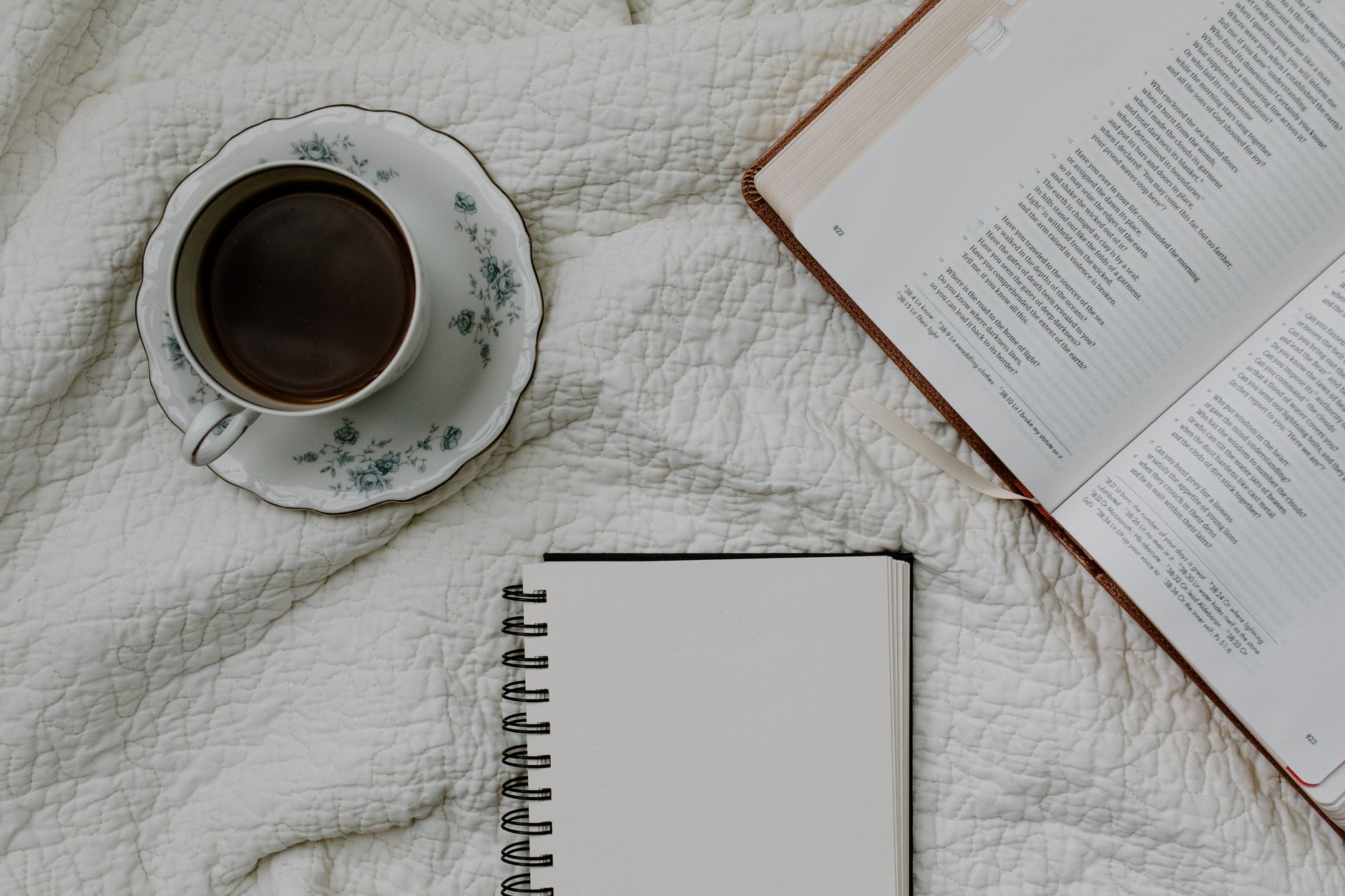 Open Bible with coffee and journal — daily devotional app
