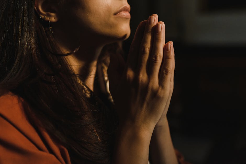 Woman with hands folded in quiet prayer — faithful not because she was perfect but because she kept showing up