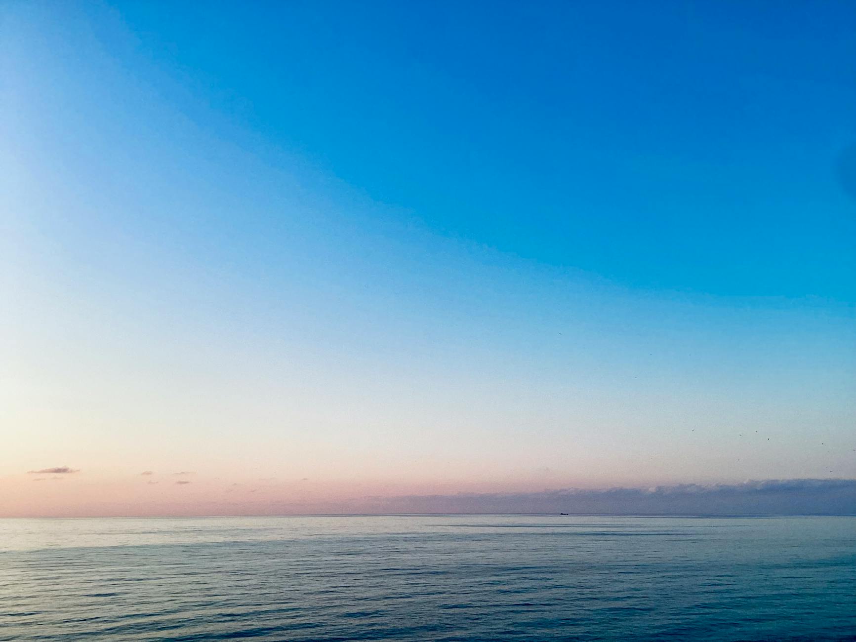 Serene ocean at dawn with pastel colors, the peace that passes understanding available before the storm