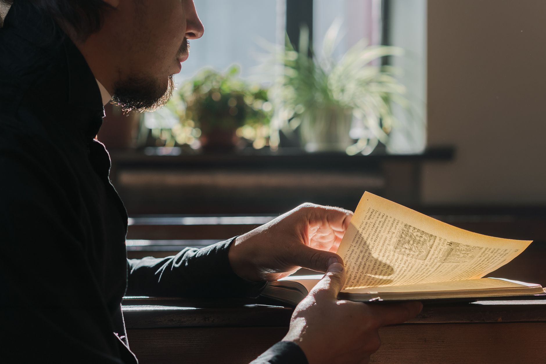 Open Bible in morning light — a man anchored in Scripture before the day begins