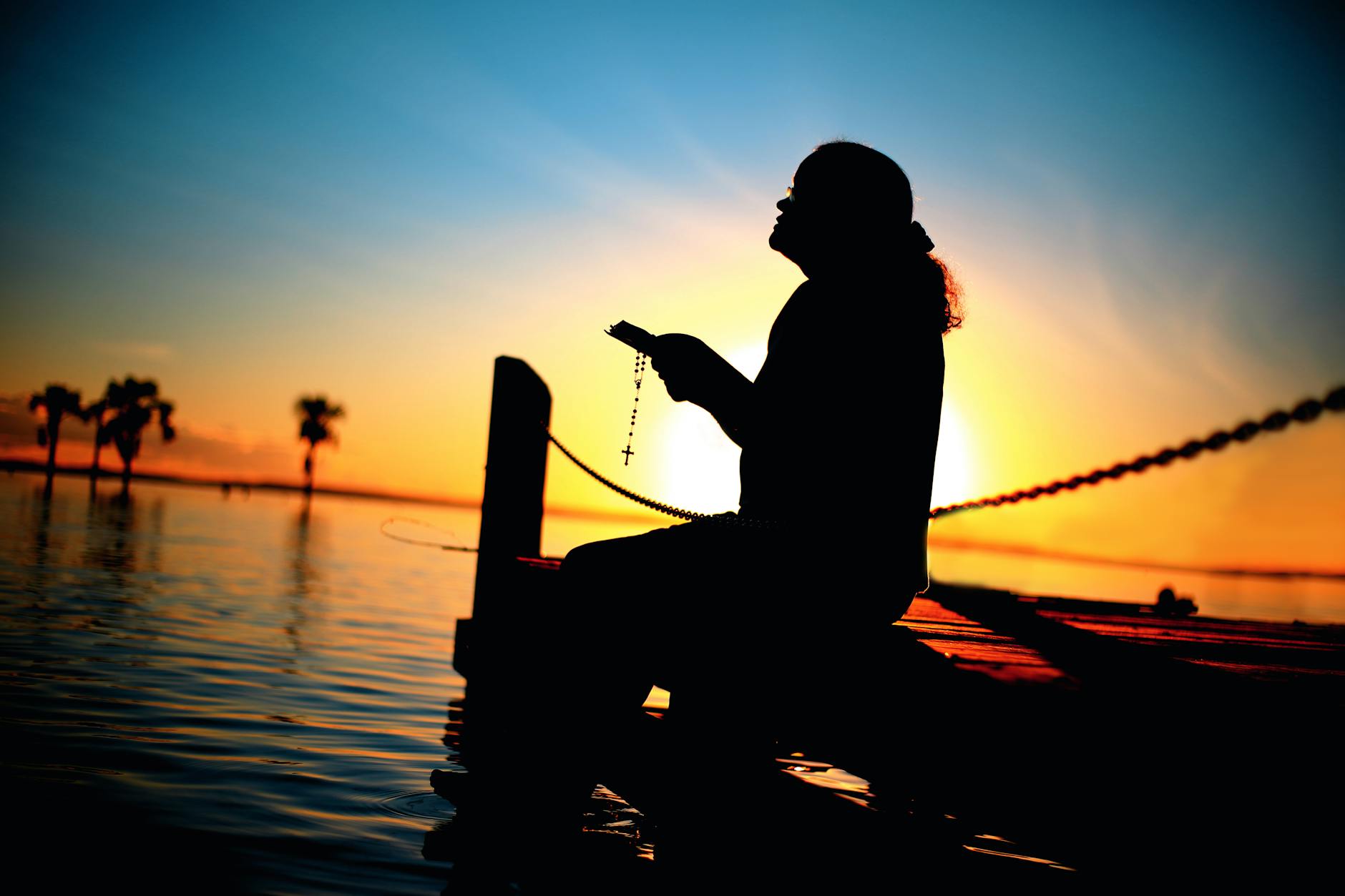 Silhouette of a woman praying at sunset, being fully known and seen by God