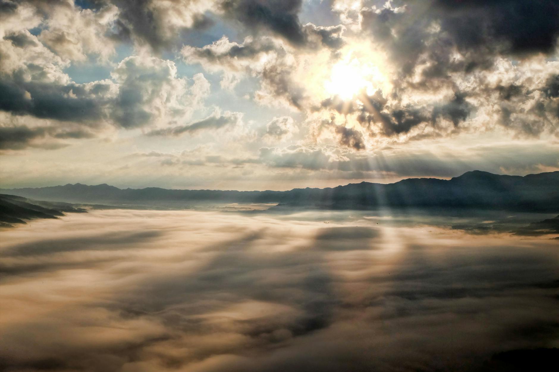 Sunlight breaking through clouds over a mountain, representing God's deliverance in every season