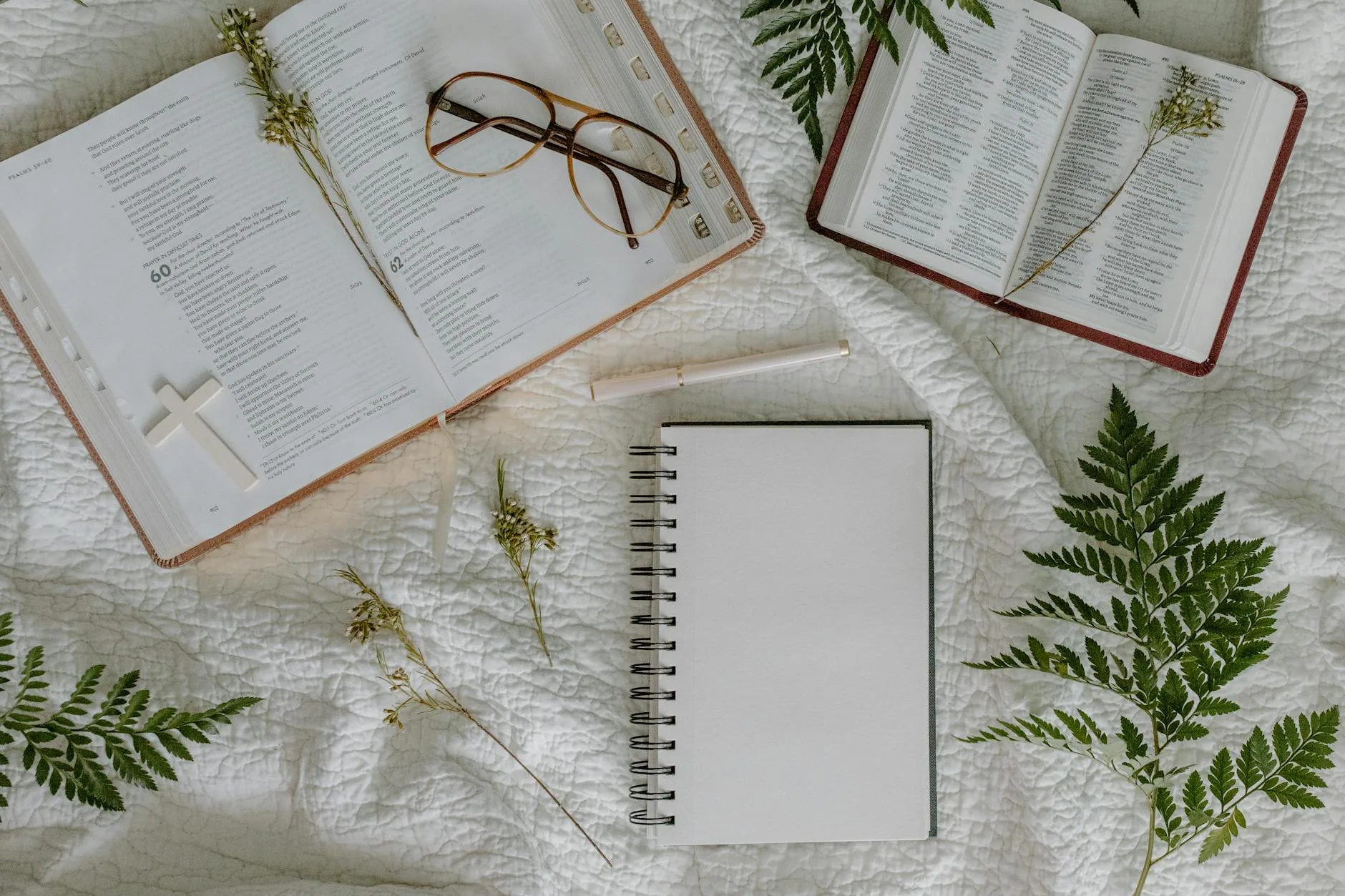 Open Bible and journal on a quilted surface, reading John 3:16 slowly and letting every word land
